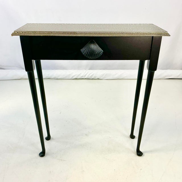 This console table from the 1990s features a very thin shape which is perfect for a hall table. It’s under 11” deep. The...