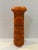 Striking mid-century stoneware vessel featuring a vivid orange glaze with heavily textured geometric relief decoration....