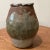 This rare and superb handcrafted peace. It has a brown heavily textured and irregular stoneware body with a neck formed...