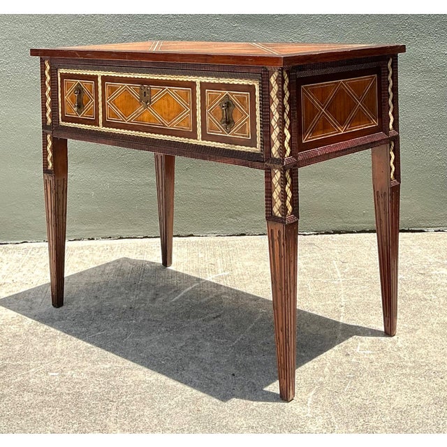 This vintage console table by Alphonse Marina exemplifies refined mid-century craftsmanship through its carved wood...