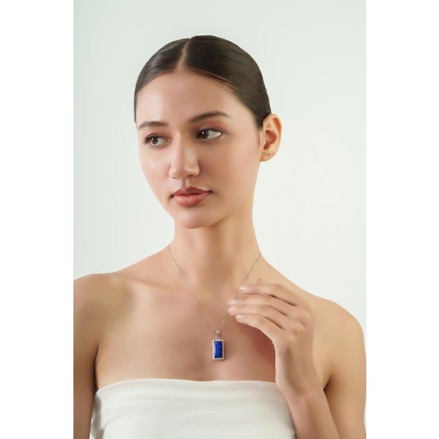 The Artisan Rectangular 13.98 Ct Lapis Lazuli Cabochon Pendant in 925 Sterling Silver features a striking 13.98-carat...