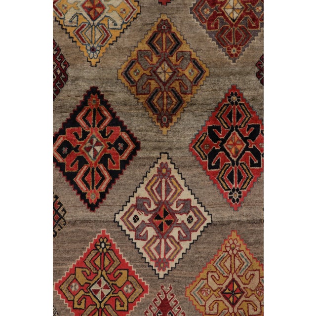 Hand-knotted in wool and originating circa 1950-1959 from Afghanistan, this 4x6 vintage Gabbeh joins Rug & Kilim’s Vintage...