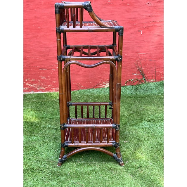 A vintage bamboo shelf, most likely dating from the mid-late 20th century, though the exact date and location of are...