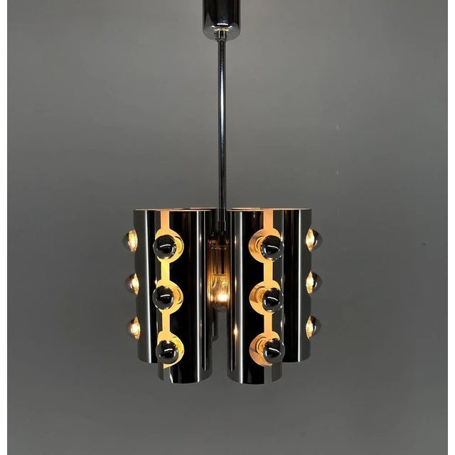 Beautiful chrome chandelier in style of the Italian designer Gaetano Sciolari. Made in Italy in the 1960s. Very good...