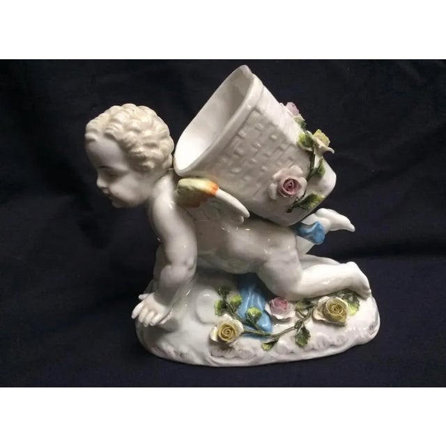 This is a beautiful large antique faint marked Sitzendorf cherub spill vase that measures 6 inches long by six and three-...