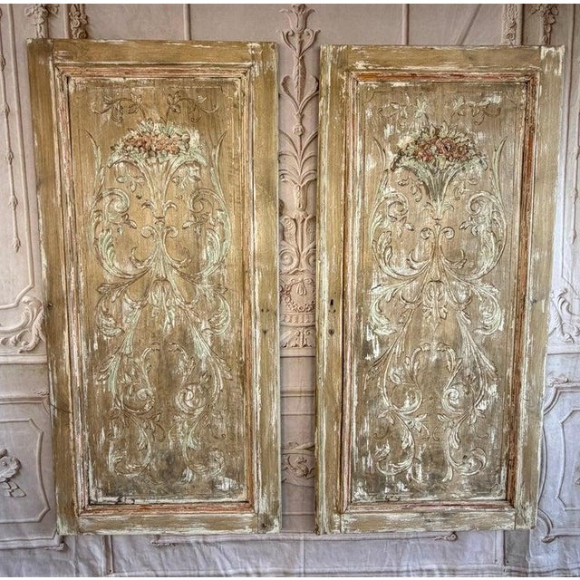 An exquisite and rare pair of antique French boiserie panels, brimming with romantic history and untouched time-worn...