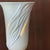 A dramatic ceramic italian uplighter in a soft matt tactile finish with draped detailing. Once illuminated the light glows...