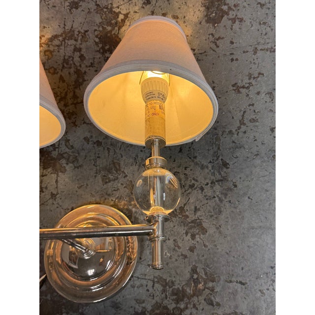 Design Plus Gallery presents a Wilshire Sconce from Restoration Hardware. This sconce showcases a dual-arm design anchored...