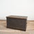 An original antique wooden pine chest originally used as a Victorian travel trunk. The trunk has a black finish and...