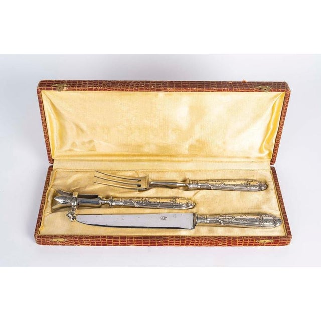 Napoleon iii period silver flatware set, 19th century, consisting of a serving fork, a serving knife and a leg of lamb...