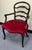 Striking carved antique French Ladderback armchair. Gracefully arched and curved ladders anchored by the carved arms...
