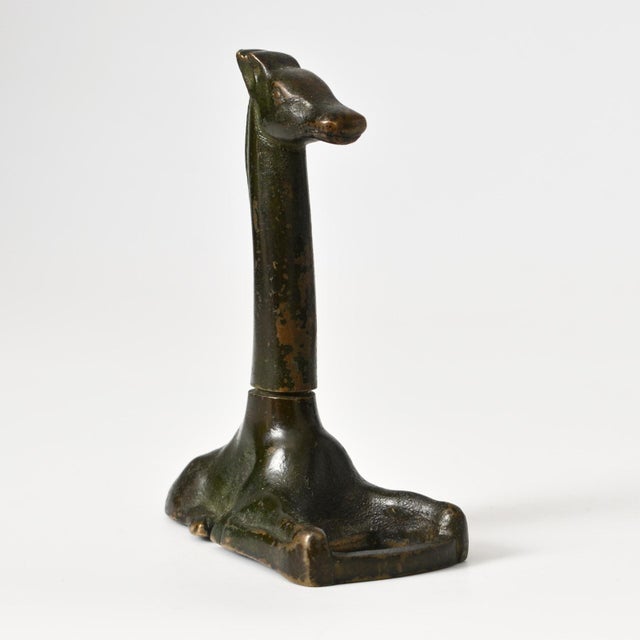 Danish art deco bronze giraffe-shaped corkscrew with bottle opener. Marked on the base: Eneret / Bronce / Kai Stage. This...