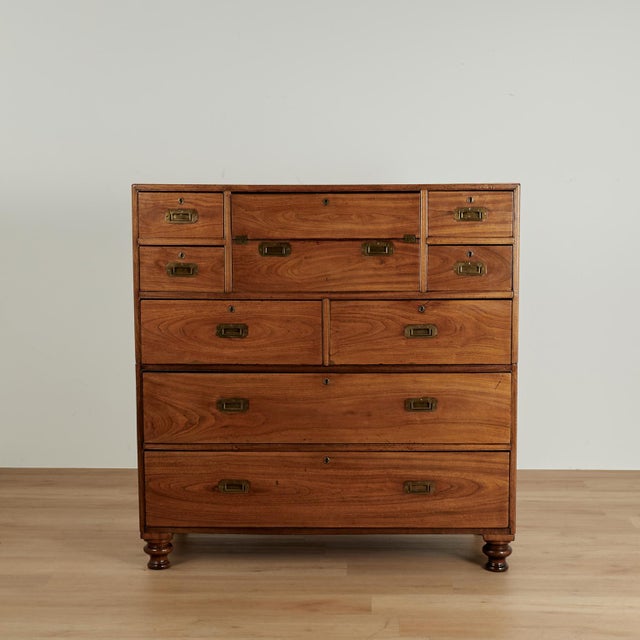 Impressive 19th century campaign chest handcrafted in exotic camphor wood with eight drawers, brass hardware and turned...