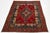 This vintage handmade Persian Tabriz wool rug features a striking red background adorned with a vibrant rosette motif and...