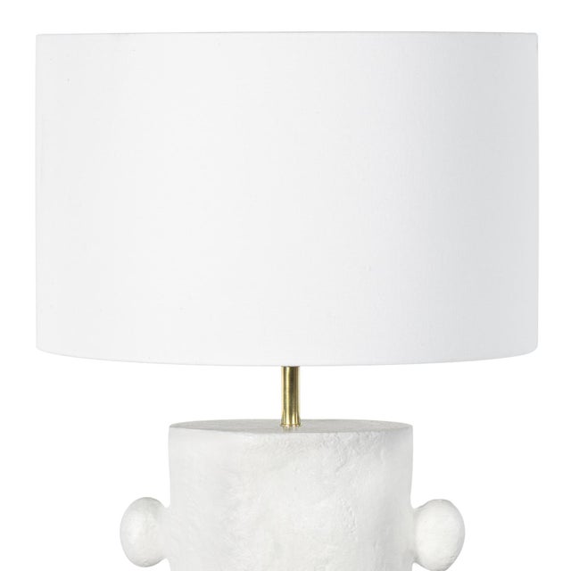 The Maya Table Lamp is rich with primitive, sculptural beauty. Maya's cast metal body and paper maché finish is the...