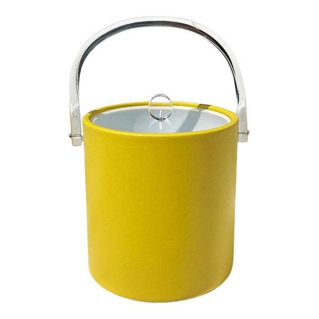 A bright yellow and lucite Hollywood Regency ice bucket or wine cooler. This bucket looks like it came straight out of...