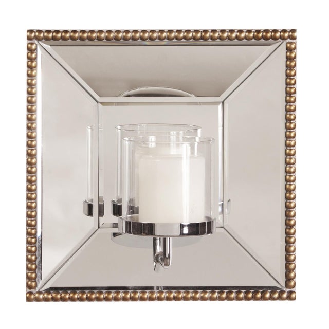 The Lydia Mirror features a square mirrored frame trimmed with an antique gold beaded border. The mirrored frame on this...