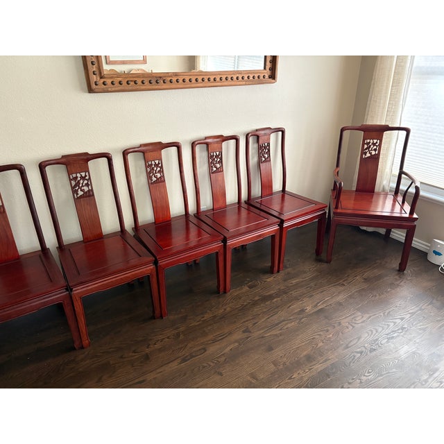 An elegant and rare set of eight matching Ming-style dining chairs, including six side chairs and two armchairs. Their...