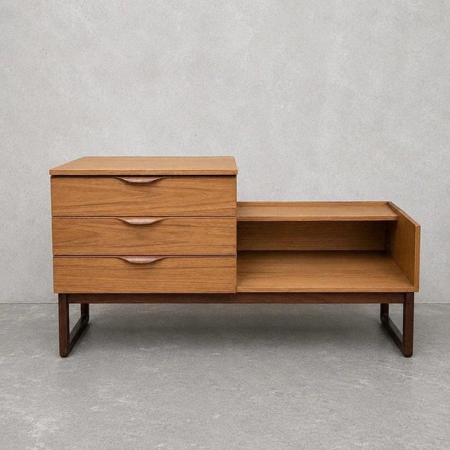 A versatile mid-century storage bench or media unit by Europa, combining a teak-veneered cabinet with a durable Formica...