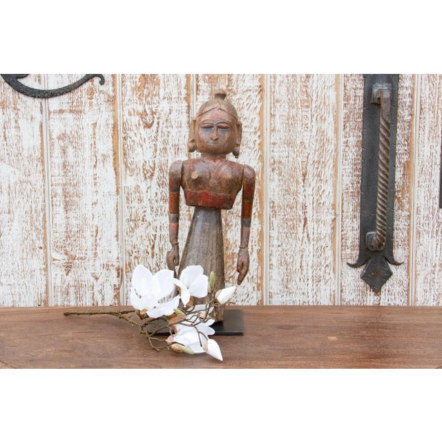 An exceptional find, this 19th century Indian doll statue is hand-carved from teak wood. This antique Indian doll depicts...