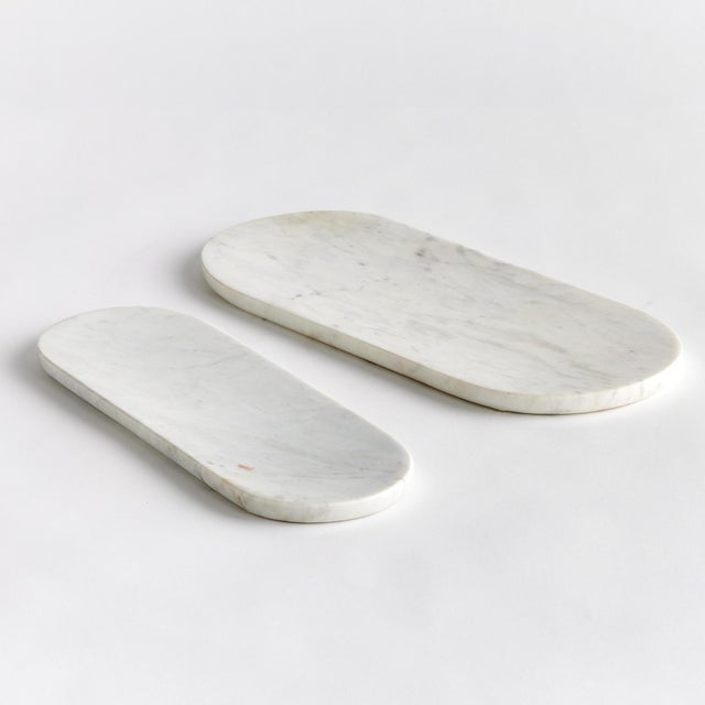 Sleek and simple, this set of oval marble trays are a great addition to any kitchen. An elegant way to serve guests a...