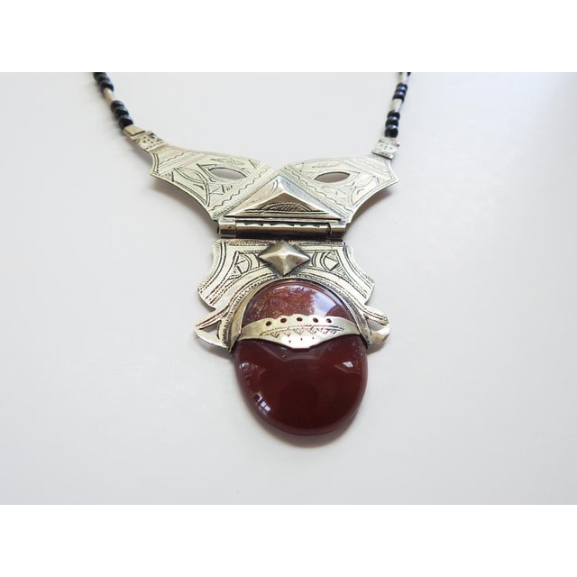 Vintage mid 20th century Tuareg silverplate necklace with carnelian cabochon stone and black glass beads. Large hinged...