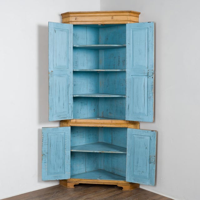 19th century 7' tall Danish corner cabinet crafted in pine. Decorative accents adorn the door panels and canted sides,...