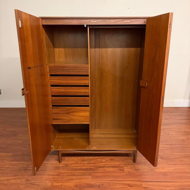 Vintage mid-century teak fitted wardrobe / armoire with rosewood accents, part of the Danish range designed by Kofod...