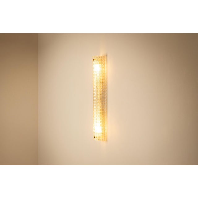 talian lighting from the 1970s often combined architectural forms with exceptional glassmaking. This large wall lamp,...