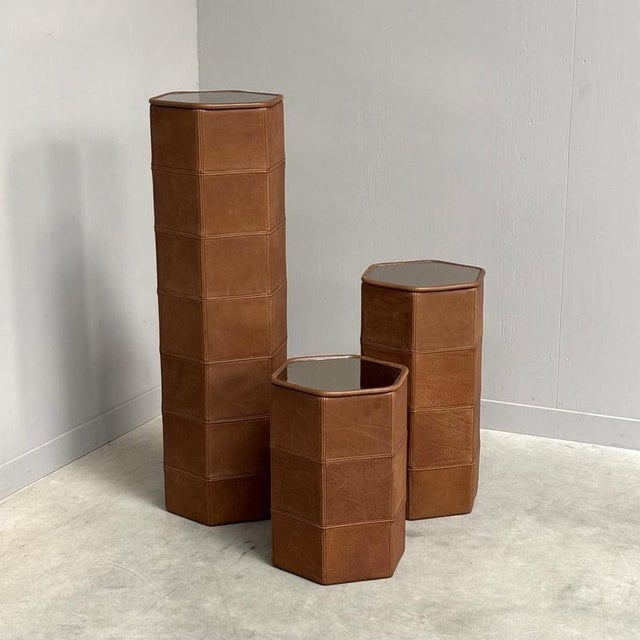 Set off three pedestals by De Sede, Switzerland 1970s. Leather covers with mirrored tops. All in excellent condition....