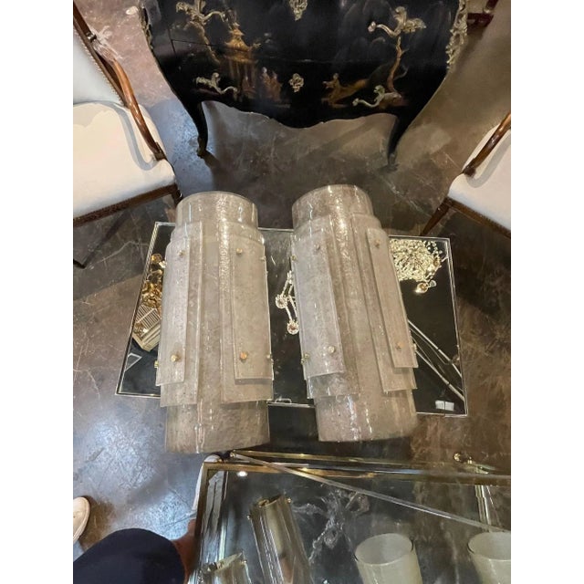 Decorative pair of modern large scale smoke glass Murano sconces. Featuring beautiful shimmering glass in layers. A...