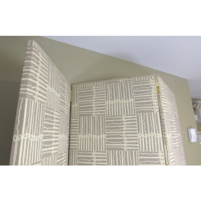 Here is a three-panel modern style room divider/screen. It is covered with a textured abstract tan (coffee-colored) and...