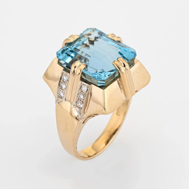 Stylish vintage estimated 11 carat aquamarine & diamond cocktail ring (circa 1960s) crafted in 14 karat yellow gold....