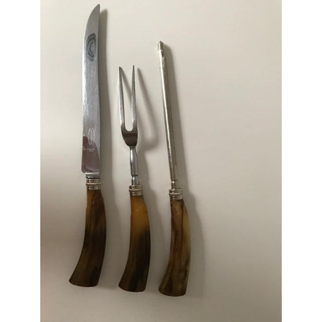 Beautiful carving set with bakelite handles and Sheffield stainless steel blades adorned with metal roped caps. The...