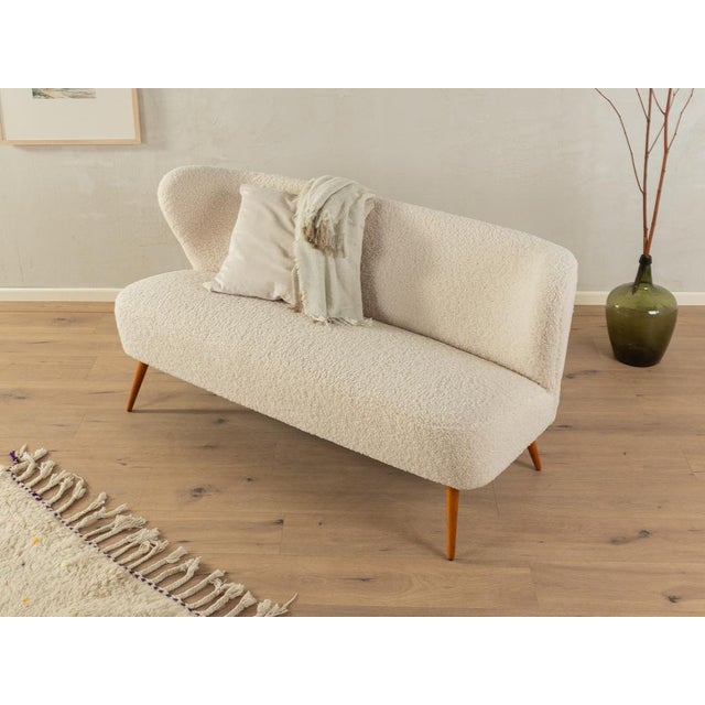 Charming cocktail sofa from the 1950s. The original spring core has been reupholstered and covered with a high-quality...