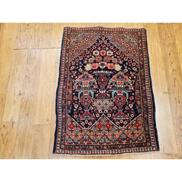"An exquisite early 20th century Persian Isfahan miniature rug in a rare and enchanting pictorial vase design — a...