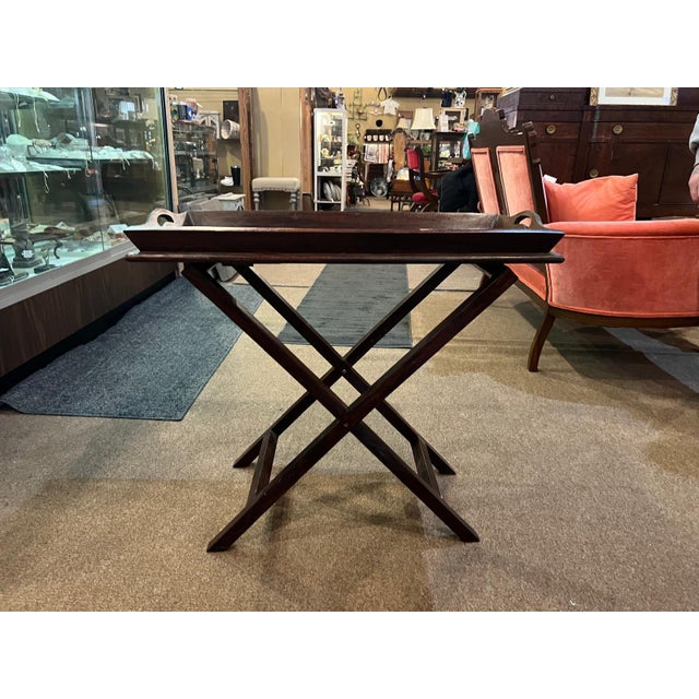 A versatile folding wood tray table featuring a rich dark wood finish and a classic X-base design. The removable tray top...