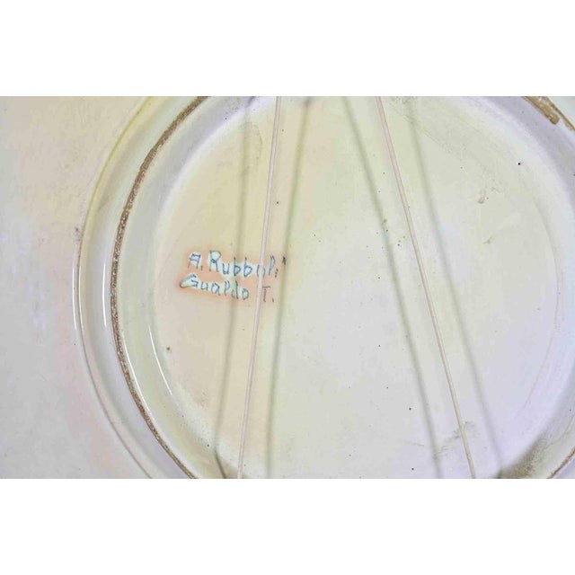 A richly decorated ceramic plate realized by Alberto Rubboli in Gualdo Tadino, in the mid-20th Century. Signed on rear....