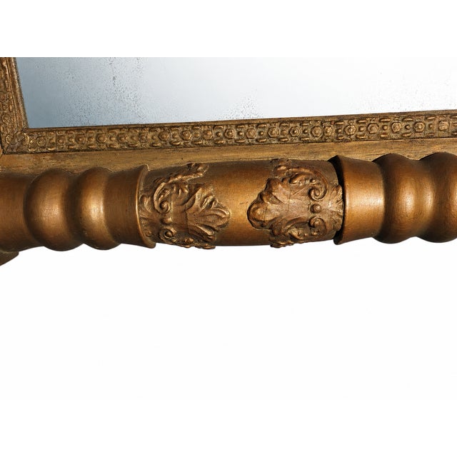 An original antique American Empire period wall mirror, dating from the circa 1830 to 1850 era. The structural design...