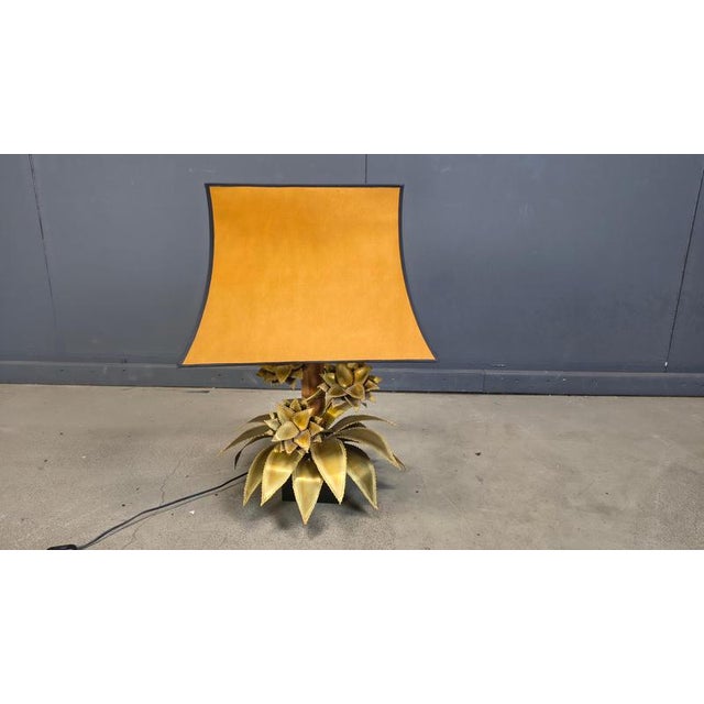 Beautiful torch cut brass floral table lamp by Maison Jansen. This palm lamp has a top mounted light point. Base is made...