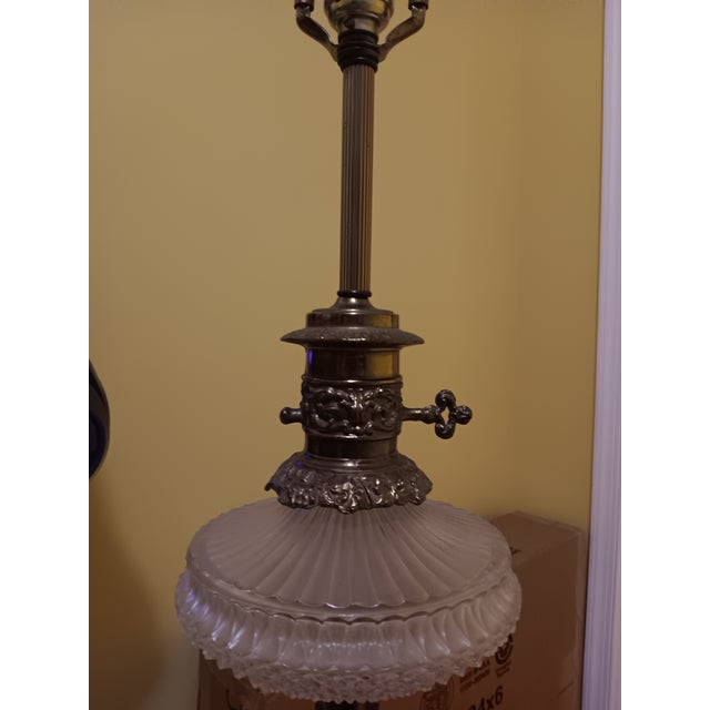 Beautiful gold on brass vintage 20s/30s floor lamp. 59" from floor to top of finial. Cut crystal centerpiece. New shade....