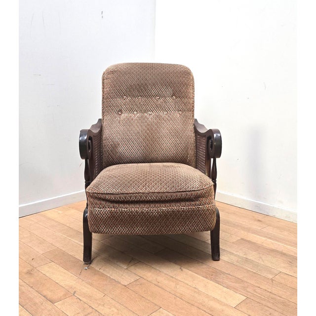Vintage English-style armchair. Dark wood frame and caning. Wool-upholstered seat with a patterned design. Very...