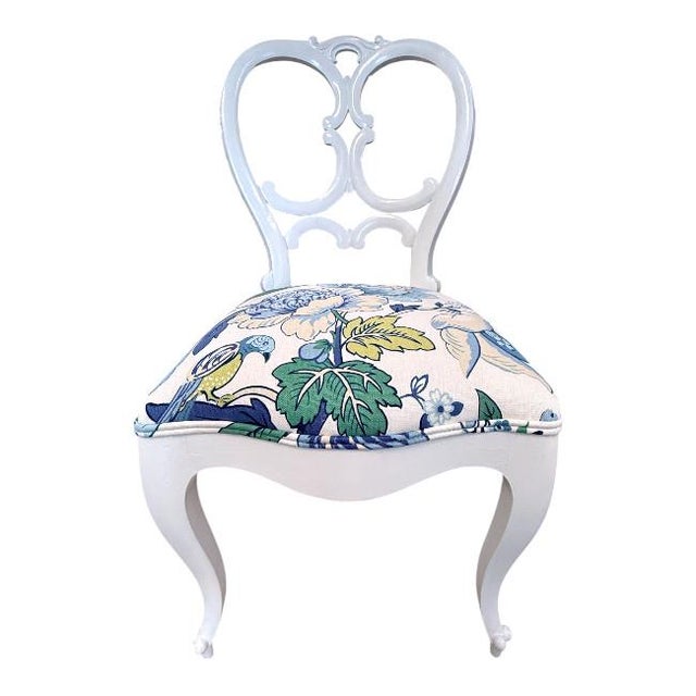 Elegant antique side chair featuring a beautifully carved frame with white painted finish. The back showcases a graceful...