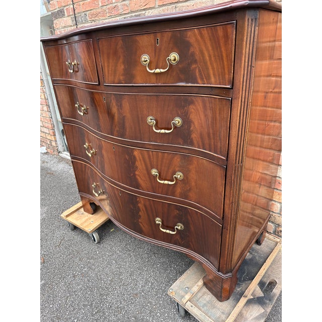 This is a beautiful mid 19th century English serpentine front chest. The wood Is a flamed mahogany, and it is flamed! In...