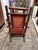 Crafted from dark turned wood with traditional spindle and spool turnings along the back and sides. Features a vibrant red...