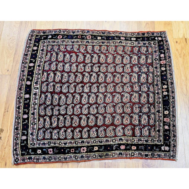 This exceptional Persian Tehran area rug, woven circa the early 1900s, features an exquisite allover paisley design on a...