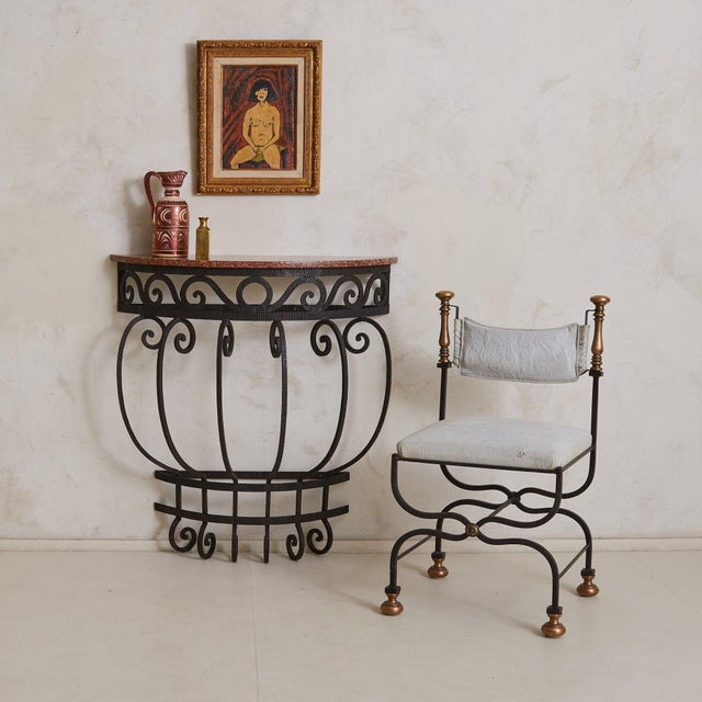 Hand-forged in France in the 1940's this half-moon console pairs sculptural ironwork with a warm Rosso Verona marble top....