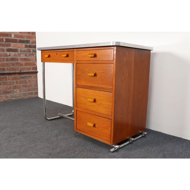 Bauhaus-style diminutive student desk/writing table with tubular chromed-steel base and beech frame with bakelite pulls...