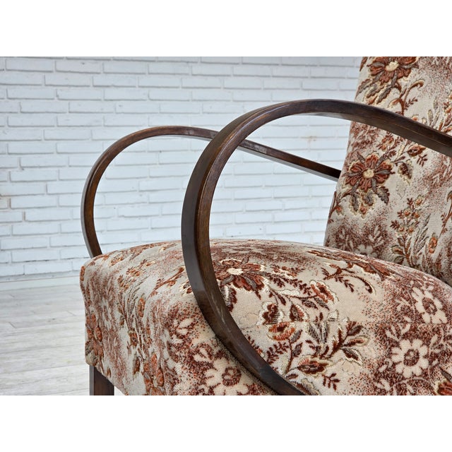 1950s, Danish artdeco armchair. Multicolor brown furniture velour, beech wood, springs in the seat. The chair was...