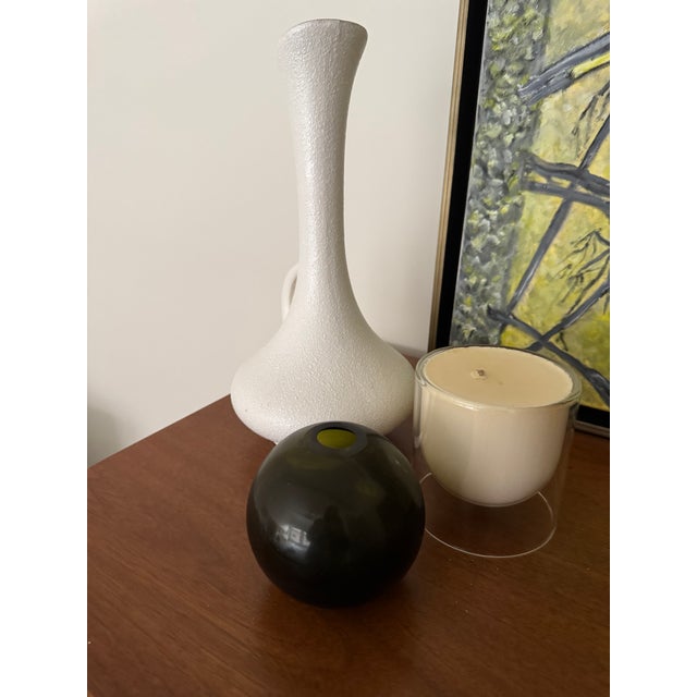Authentic vintage Haeger Potteries bud vase featuring a textured matte white exterior and contrasting avocado green...